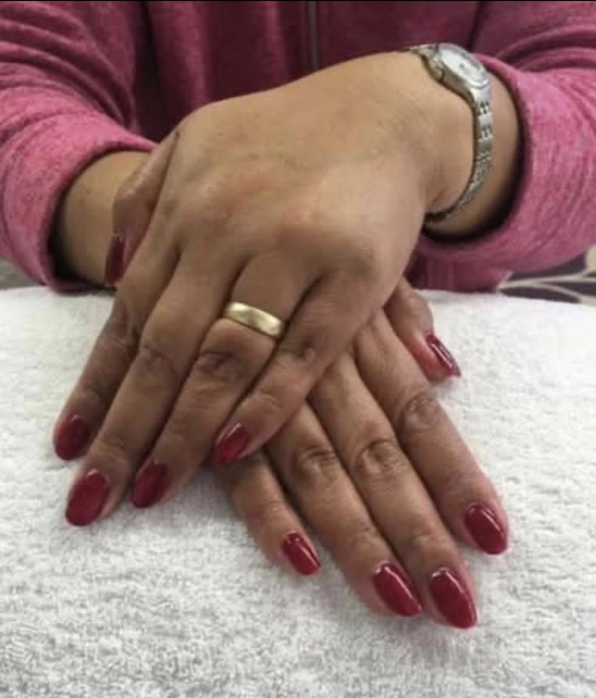 Statement matte black gel manicure on a white towel.