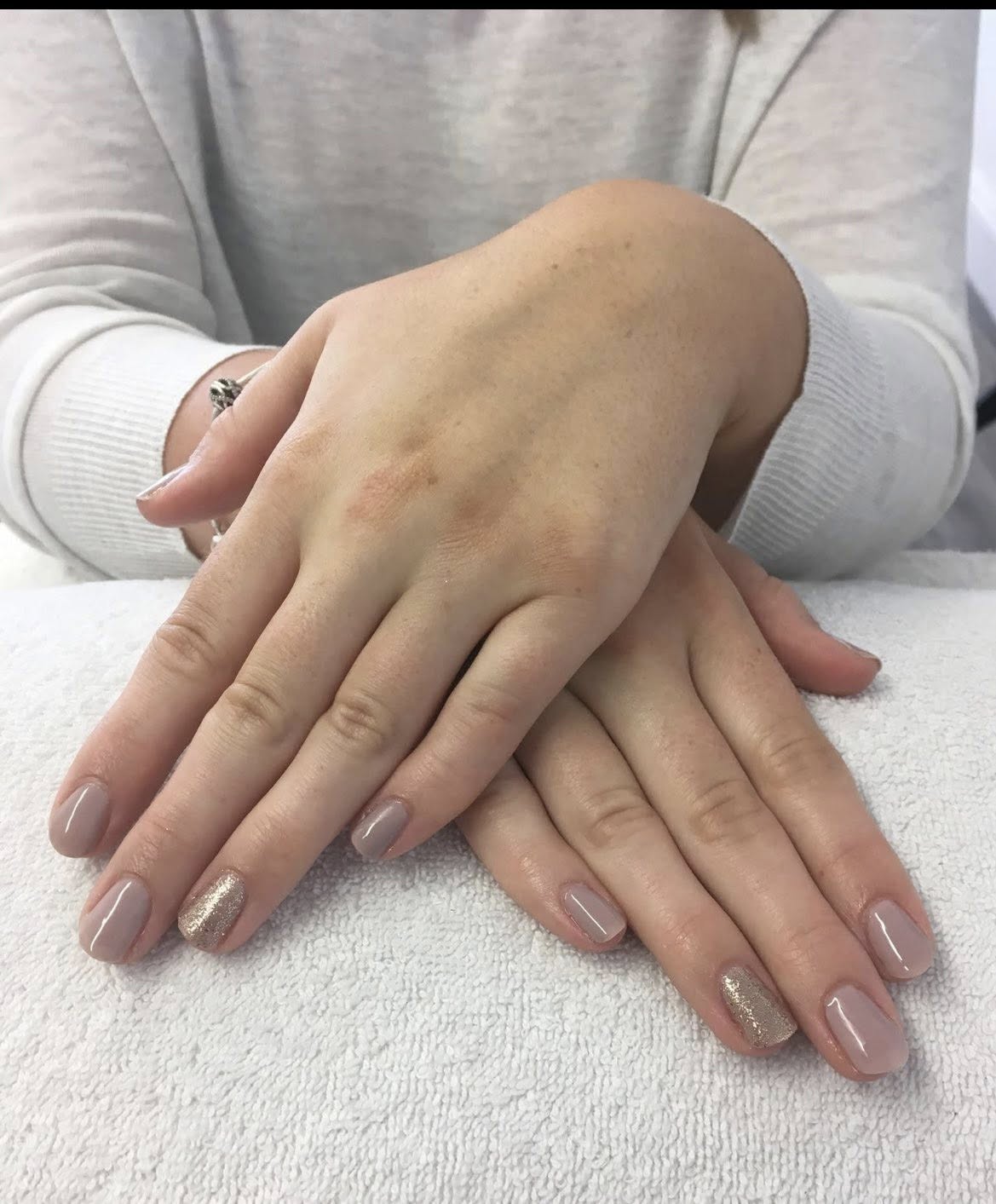 French manicure with a rose-gold glitter accent nail.